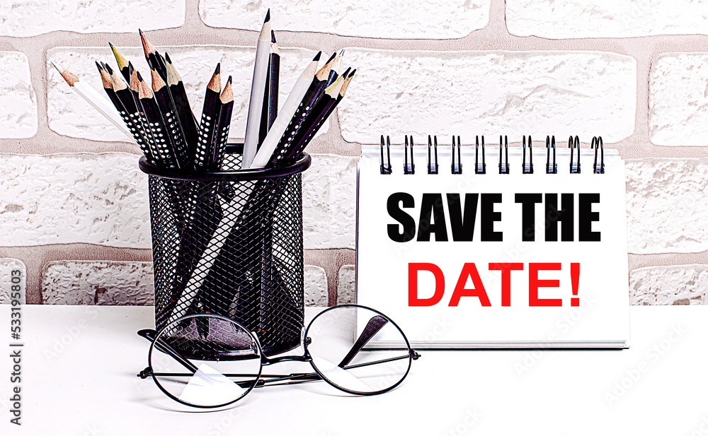 Aufkleber a workplace in the house with glasses, pencils in a stand and a notebook with text save the date on 