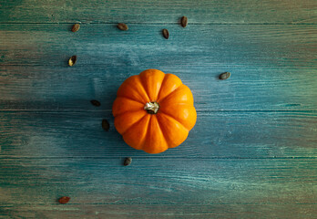 orange pumpkin on blue and colorful wooden background, ideal as a background for Halloween or autumn theme, orange pumpkin isolated - 533196246