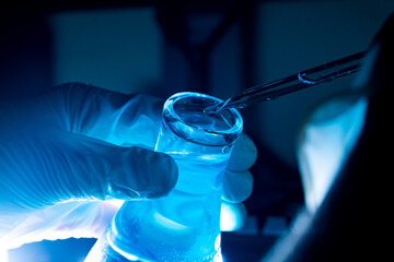blue glass test tube,Asian female scientist with test tubes doing research in clinical laboratories...