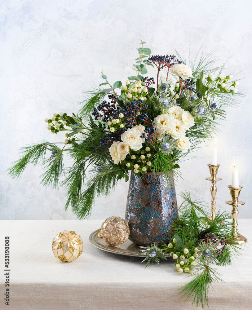 Poster Christmas decorations, candles and flower bouquet. Winter arrangement with roses, fir branches, winter berries. Christmas flower still life.