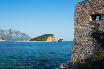 Fototapeta premium Old defensive walls of Budva and Sveti Nikola island in the background