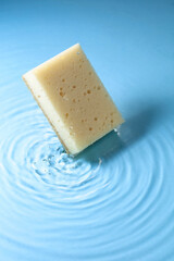 The sponge falls into the water.