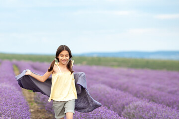 Happy girl in the lavender field. child running