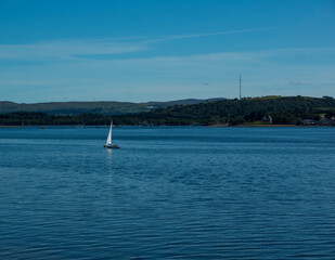 Obraz premium Landscape of Gare Loch with single sail boat
