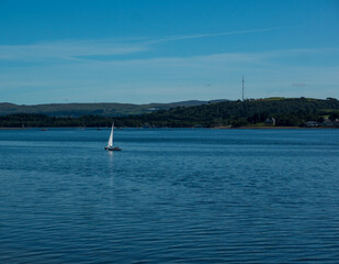 Landscape of Gare Loch with single sail boat