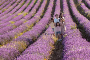 Portrait of a mother with her daughters on a background of lavender
