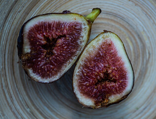 whole juicy ripe black fig cut into halves closeup detail - 533203893