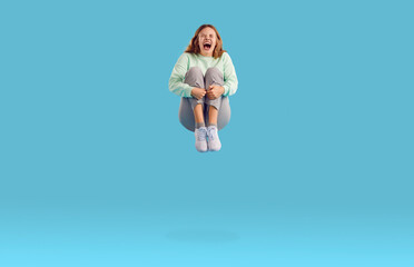 Full body length shot of happy funny crazy joyful excited young Caucasian woman in trousers and...