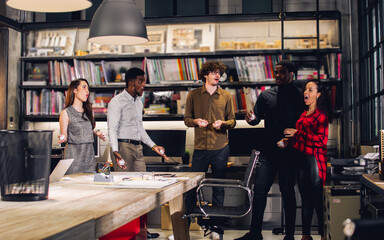 Obraz premium Group diverse multiracial businesspeople wearing casual clothes in modern office, taking break, rest, playing games with relaxation, throwing paper ball to the target. Achievement, Success Concept.