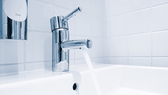 Bathroom water mixer. Water tap made of chrome material, Faucet with water in blue tone