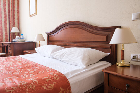 Modern, warm, inviting bedroom or hotel room.