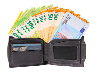 A black leather wallet with credit cards is open, it contains euro banknotes folded in a fan. Isolated on white background.