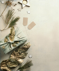 Christmas background with sustainable gift package and various holiday decoration. Top view