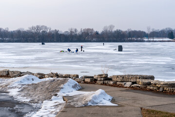 Ice Fishing On A Frozen Over Fox River In De Pere, Wisconsin, In Late January