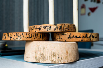 Ash wood paper towel holder. Beautiful texture. The pattern on the bark is encircled with acrylic paint and is similar in spelling to the Japanese characters "life" and "laughter" Close-up.