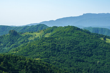 Georgian mountain landscape with a country road, a view of the woodlands