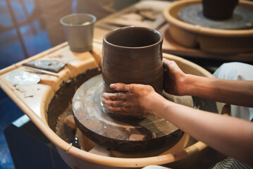 Close up hand potter preparing ceramic clay to making pottery vase, workshop in hand craft studio, Art and hobby handmade concept.