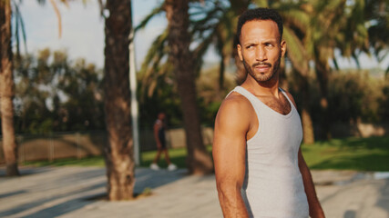 Close up, young bearded male fit athlete walks after training