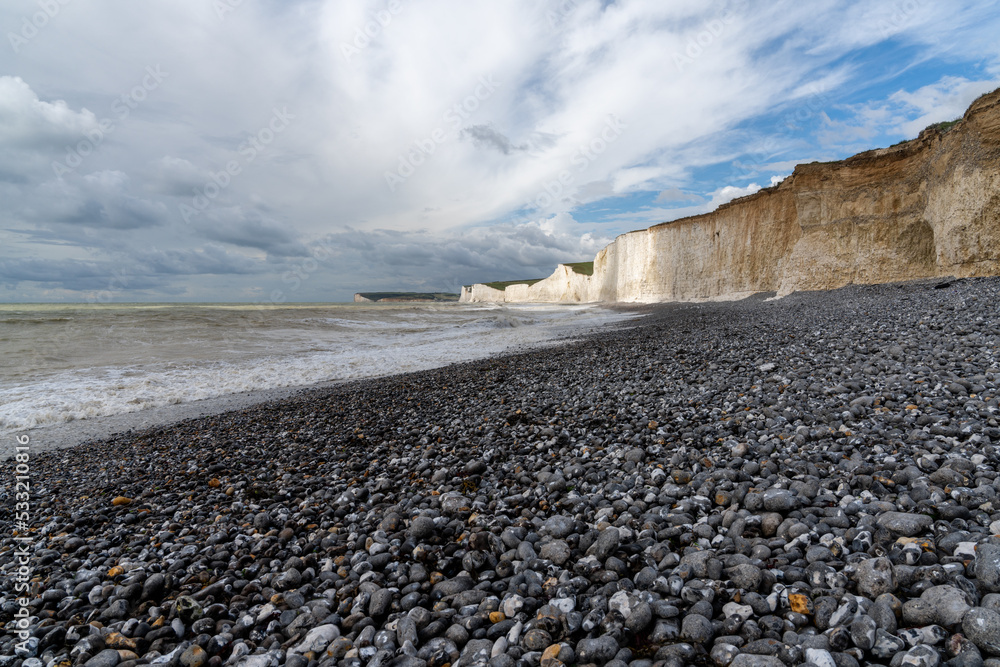 Wall mural rocky beach at Birling Gap with the cliffs of the Seven Sisters in the background on the Jurassic Coast of East Sussex