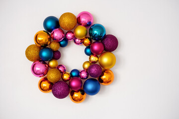 A wreath of colorful Christmas glass balls on a white background . New Year's decor element