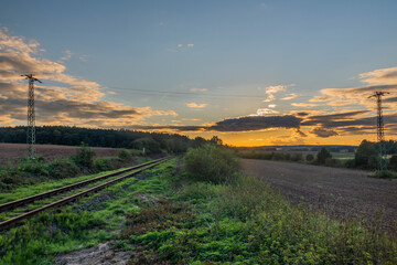 Old non electrified railway track near Rakovnik town in sunset evening