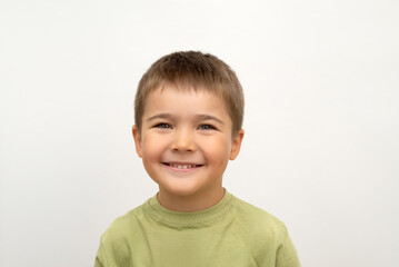 little cute boy smiling. face of a happy child close-up on a white isolated background. portrait of a 5 year old baby