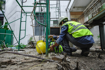 Accident of builder worker in work at construction site. Accident falls from the scaffolding on...