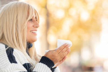 woman with cold or allergy with handkerchief