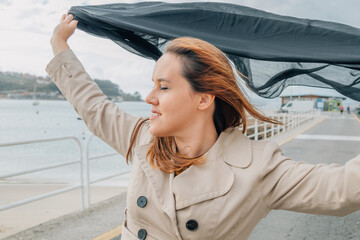 woman in the street with a scarf or foulard in the wind