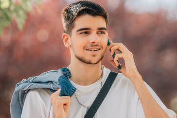 young man talking on mobile phone in the street