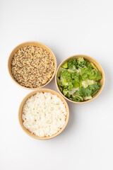 Three poke with quinoa, rice and green salad on white background