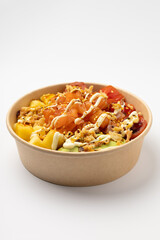 Poke with salmon, pineapple and avocado with spicy sauce on a white background