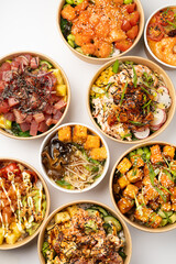 Several poke with fresh salmon, tuna, sauce on a white background