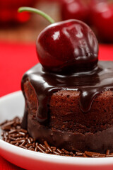 Chocolate cake with cherries on the table.