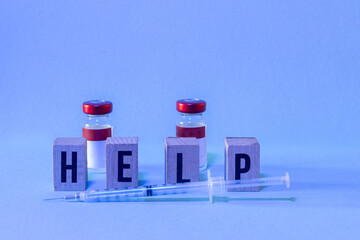 two doses of vaccine one syringe and HELP letters with copy space