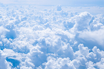 Many white cumulus clouds. Aerial view from airplane window. Background with copy space.