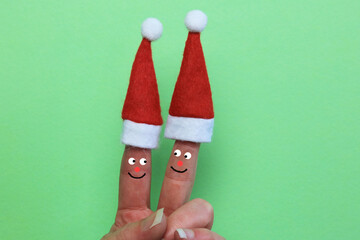 two Christmas hats on a pair of fingers. couple merry Christmas concept
