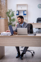 Young male employee working in the office