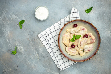 dumplings with cherries, Pierogi, varenyky, vareniki, pyrohy on a light background, banner, menu,...
