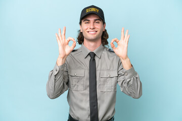 Young safeguard man isolated on blue background showing an ok sign with fingers