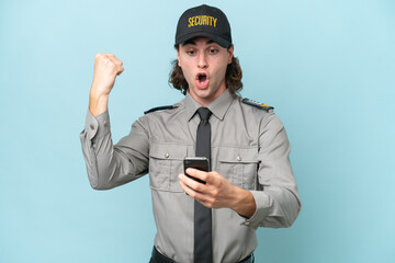 Young safeguard man isolated on blue background surprised and sending a message