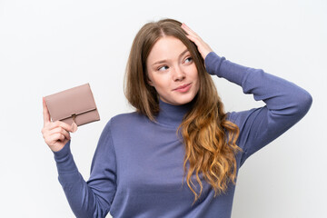 Young pretty woman holding wallet isolated on white background having doubts and with confuse face...