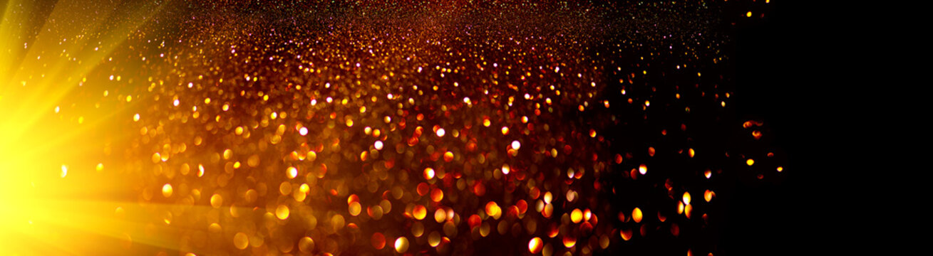 Golden sparks, Christmas and New Year glittering stars swirl on black bokeh background, backdrop with sparkling gold, holiday garland, magic glowing dust, lights. Gold Abstract Glitter Blink 