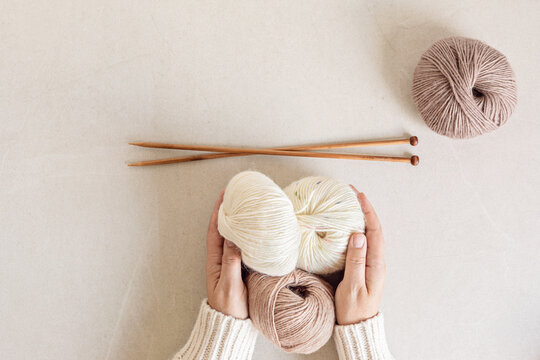 Craft hobby background with yarn in natural colors. Recomforting hobby to reduce stress for cold fall and winter weather. Mock up, copy space, top view