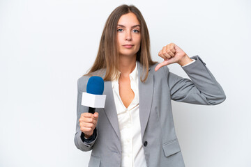 Fototapeta premium Young TV presenter caucasian woman isolated on white background showing thumb down with negative expression