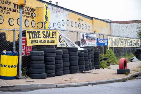 Baltimore, MD - September 25 2022: Tires For Sale On A Sidewalk Next To A Tire Store In Baltimore, Maryland