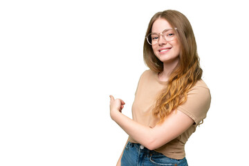 Fototapeta premium Young pretty woman over isolated background pointing back