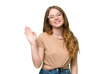 Young pretty woman over isolated background saluting with hand with happy expression