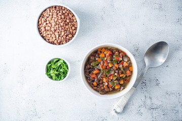 Green Lentil carrots red pepper vegan soup in a bowl
