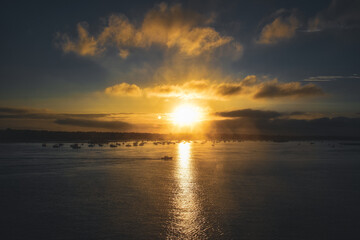 yellow blue sunset sunrise clouds over sea ocean boat port harbour